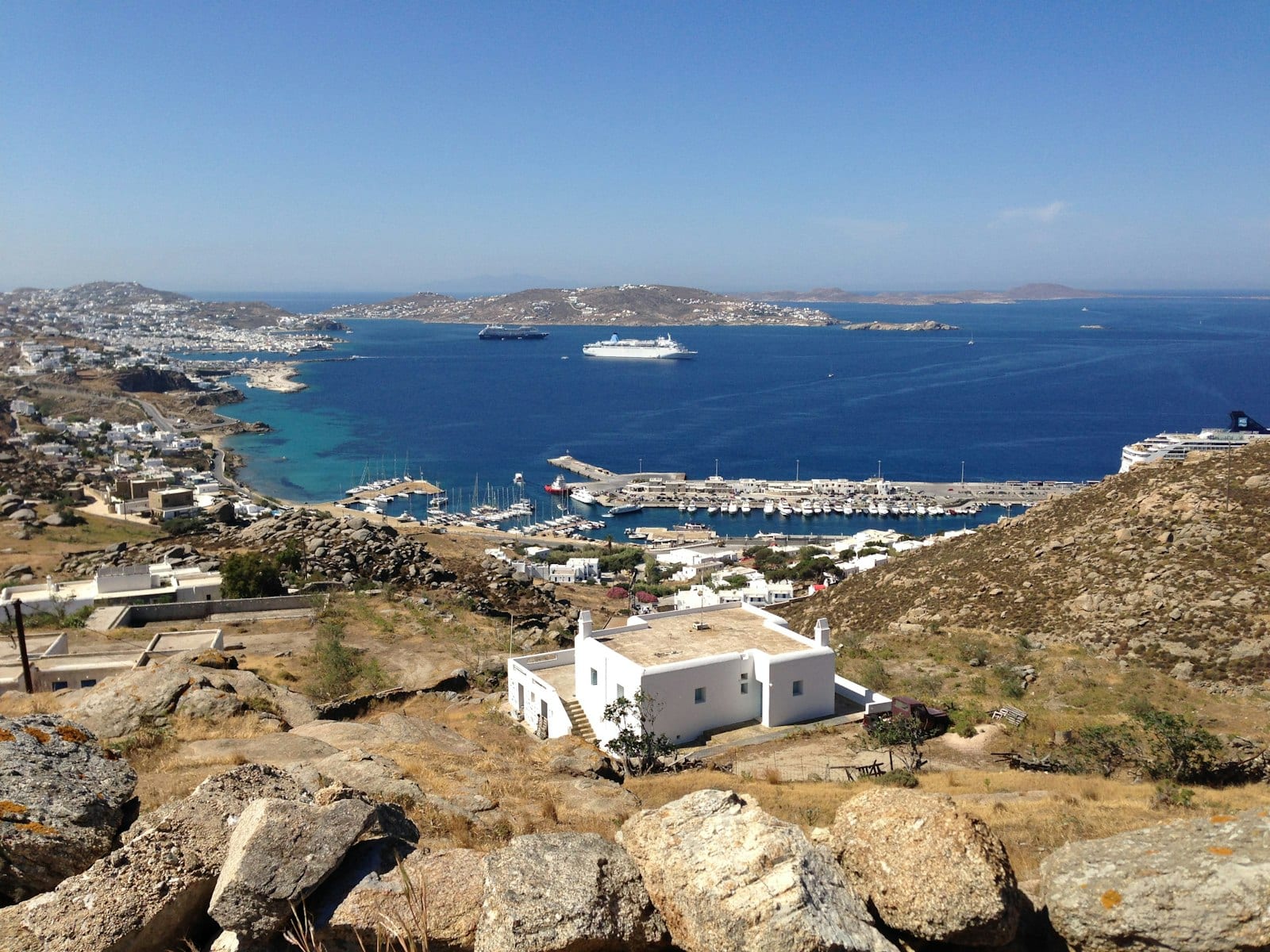 White chapel overlooking Mykonos harbour — comparing shore excursion options